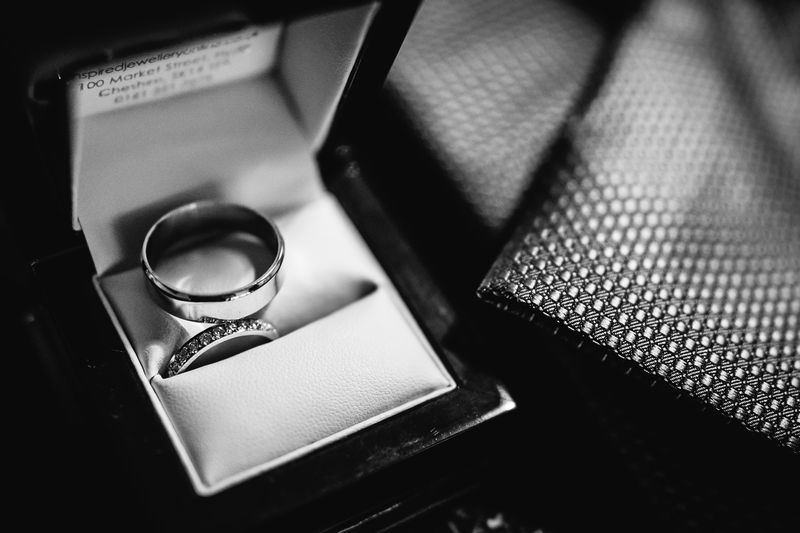 Wedding rings resting together in an open ring box